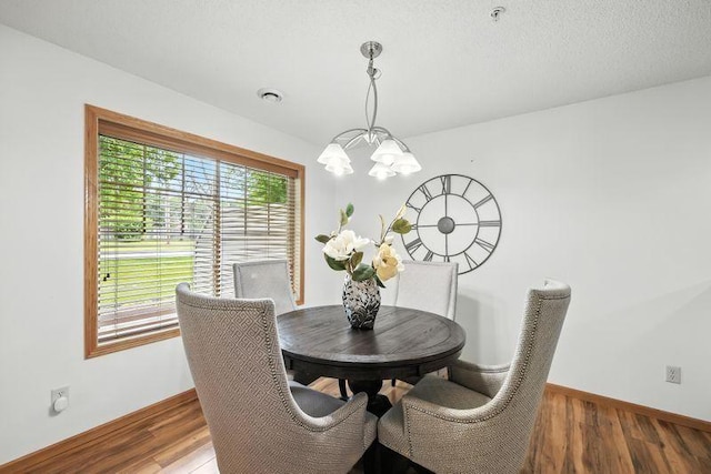 5460 100th Ln N, Brooklyn Park, MN 55443 - dining space featuring a chandelier and wood finished floors