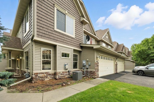 5460 100th Ln N, Brooklyn Park, MN 55443 - view of side of property with asphalt driveway and stone siding