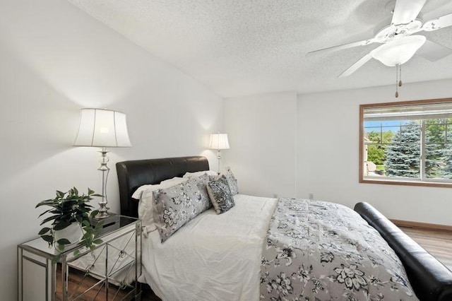 5460 100th Ln N, Brooklyn Park, MN 55443 - bedroom with a textured ceiling, a ceiling fan, and wood finished floors