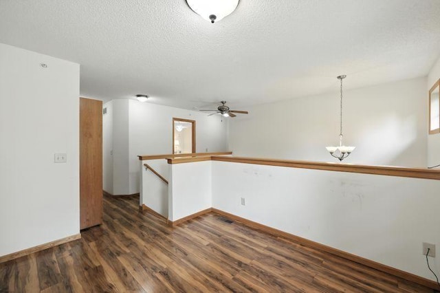 5460 100th Ln N, Brooklyn Park, MN 55443 - spare room with dark wood-type flooring, ceiling fan, a chandelier, and a textured ceiling
