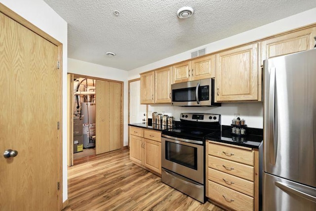 5460 100th Ln N, Brooklyn Park, MN 55443 - kitchen featuring stainless steel appliances, light brown cabinets, gas water heater, dark countertops, and a textured ceiling