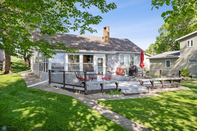 44042 Outlet Beach Rd, Lida Twp, MN 56572 - rear view of property featuring a chimney, a wooden deck, a yard, and a shingled roof