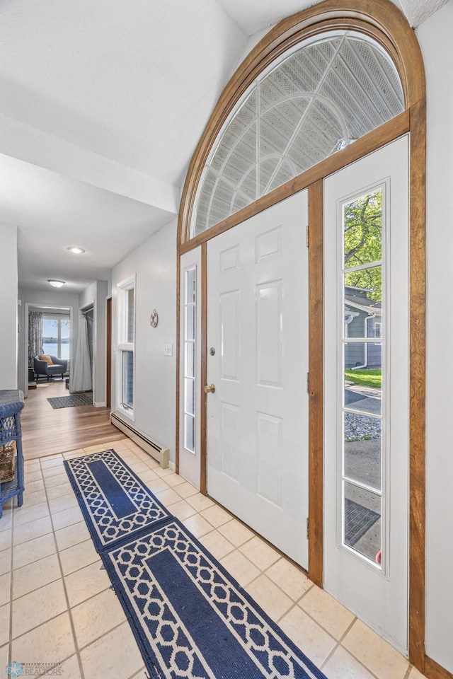 44042 Outlet Beach Rd, Lida Twp, MN 56572 - foyer featuring tile patterned floors, a baseboard heating unit, and vaulted ceiling