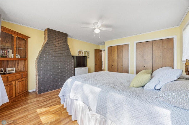 44042 Outlet Beach Rd, Lida Twp, MN 56572 - bedroom featuring two closets, light wood finished floors, ornamental molding, and a ceiling fan