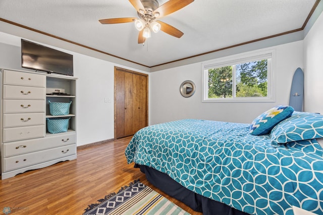 44042 Outlet Beach Rd, Lida Twp, MN 56572 - bedroom featuring wood finished floors, crown molding, a closet, and ceiling fan