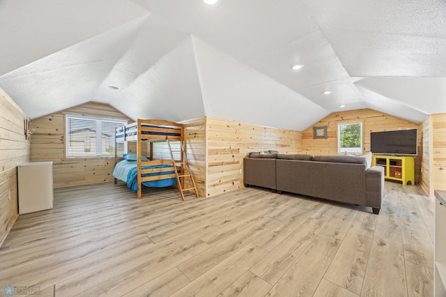 44042 Outlet Beach Rd, Lida Twp, MN 56572 - bedroom with wood walls, lofted ceiling, wood finished floors, and a textured ceiling