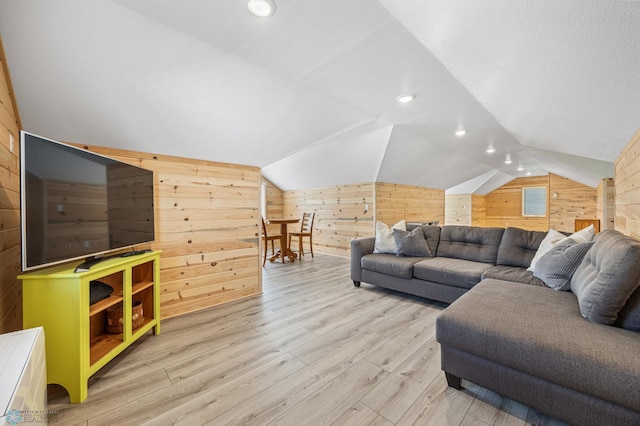 44042 Outlet Beach Rd, Lida Twp, MN 56572 - living room featuring wooden walls, light wood-style flooring, and vaulted ceiling