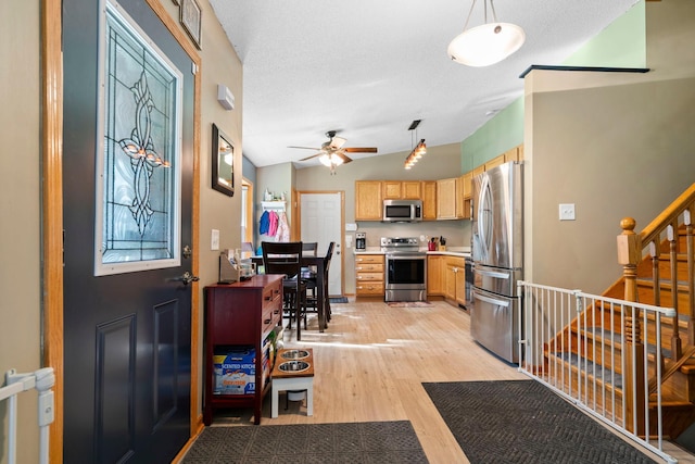 10919 Eagle St NW, Coon Rapids, MN 55433 - entryway featuring light wood-style flooring, ceiling fan, and stairs