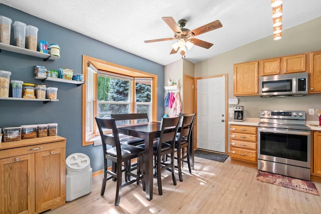 10919 Eagle St NW, Coon Rapids, MN 55433 - kitchen with appliances with stainless steel finishes, light wood-style floors, ceiling fan, light countertops, and a textured ceiling