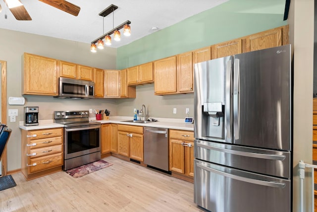 10919 Eagle St NW, Coon Rapids, MN 55433 - kitchen with stainless steel appliances, light countertops, and light wood-style flooring