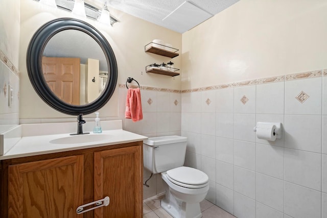 10919 Eagle St NW, Coon Rapids, MN 55433 - half bath with vanity, tile patterned floors, wainscoting, and tile walls