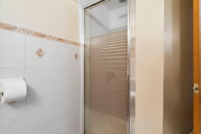 10919 Eagle St NW, Coon Rapids, MN 55433 - full bathroom with a stall shower and tile walls
