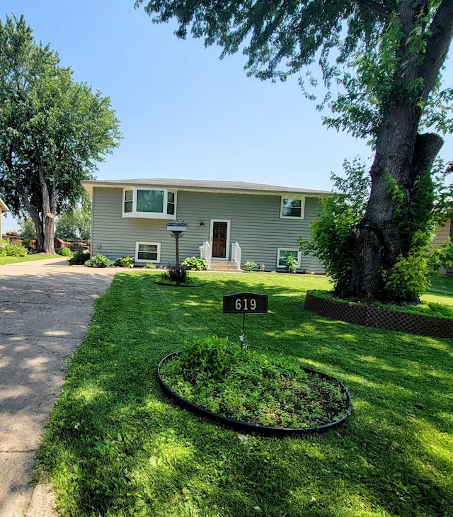 619 3rd St NW, Forest Lake, MN 55025 - rear view of house featuring a lawn and driveway