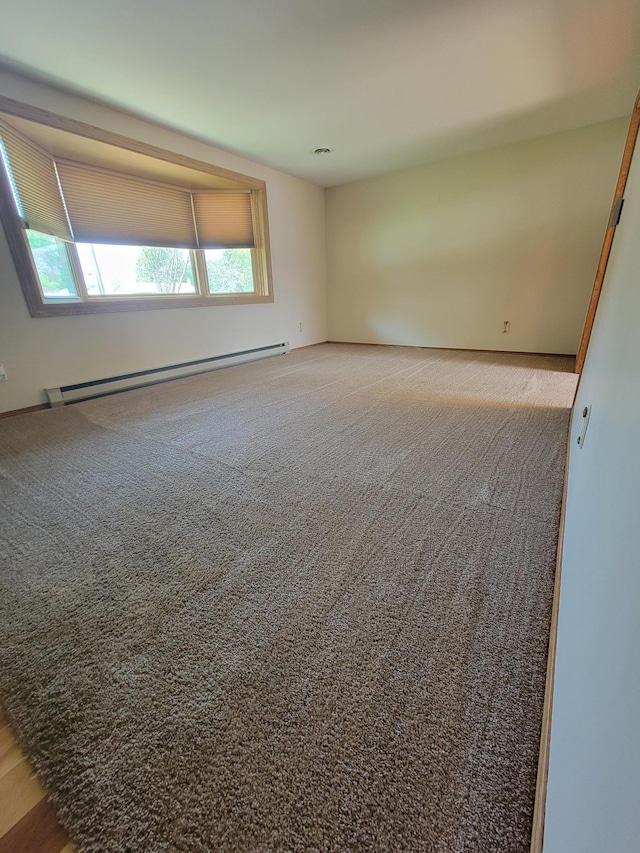 619 3rd St NW, Forest Lake, MN 55025 - carpeted spare room with a baseboard radiator and healthy amount of natural light