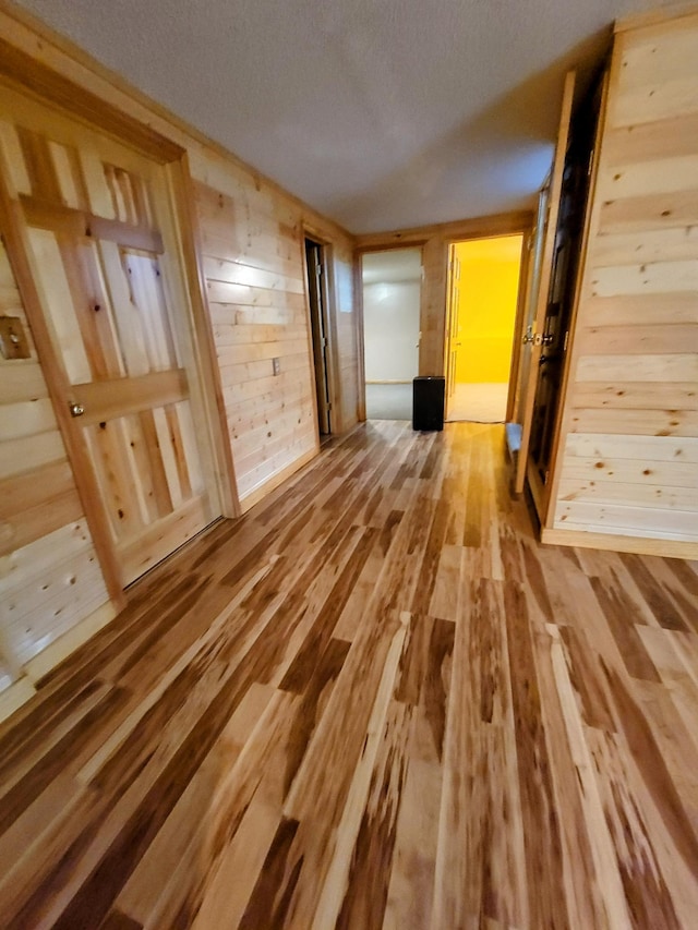 619 3rd St NW, Forest Lake, MN 55025 - unfurnished room with wood finished floors, wood walls, and a textured ceiling