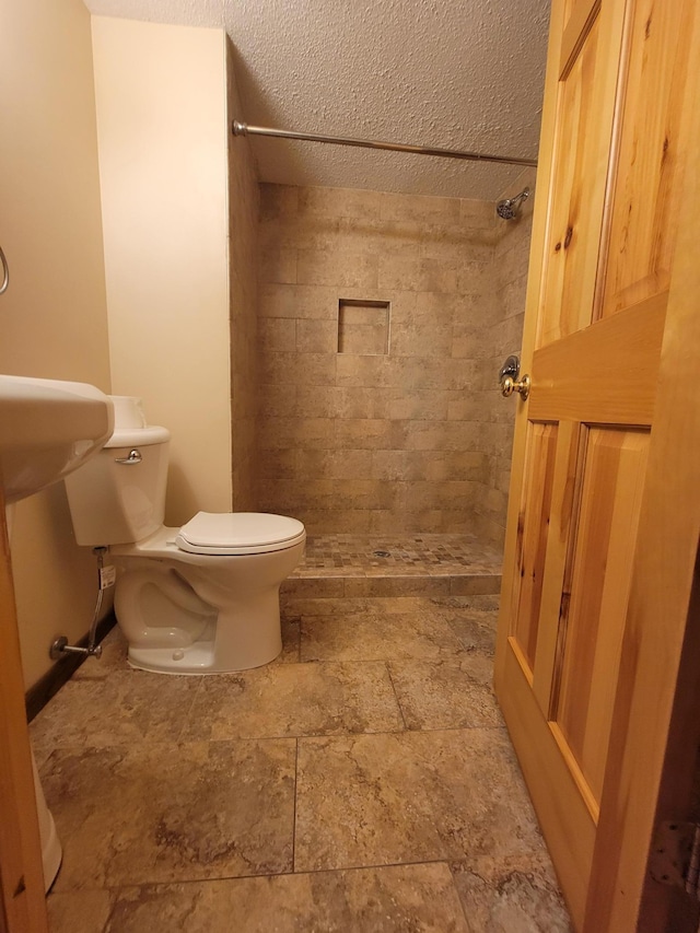 619 3rd St NW, Forest Lake, MN 55025 - full bathroom with tiled shower, stone finish floors, and a textured ceiling