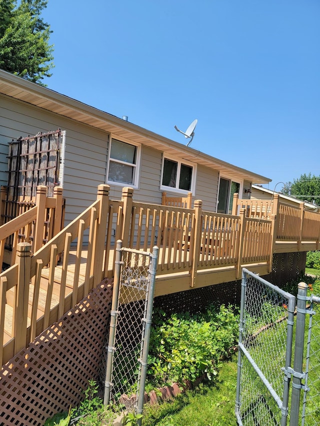 619 3rd St NW, Forest Lake, MN 55025 - rear view of property featuring a deck and a gate