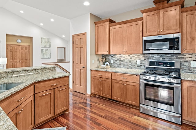 12605 314th St, Lindstrom, MN 55045 - kitchen with appliances with stainless steel finishes, recessed lighting, wood finished floors, decorative backsplash, and light stone counters