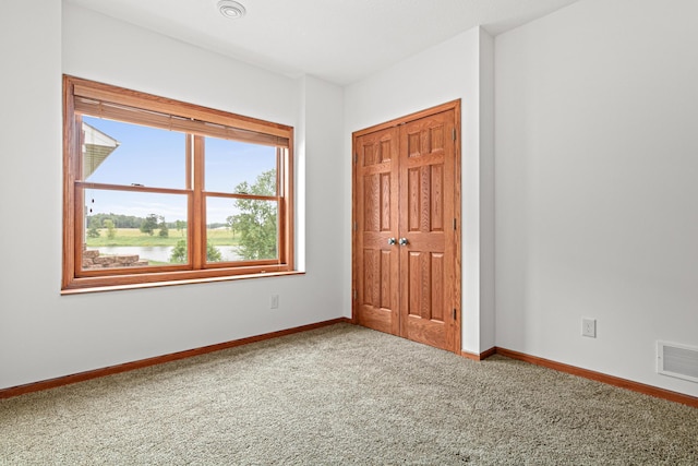 12605 314th St, Lindstrom, MN 55045 - unfurnished bedroom featuring carpet flooring, a closet, and a water view