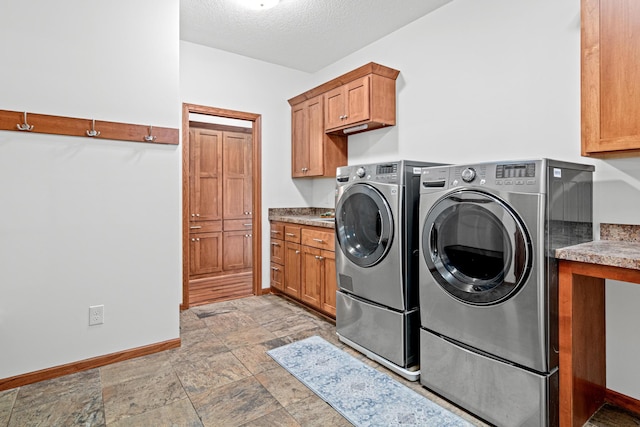 12605 314th St, Lindstrom, MN 55045 - laundry room featuring cabinet space, separate washer and dryer, light stone finish flooring, and a textured ceiling