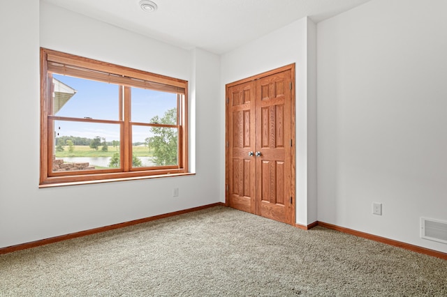 12605 314th St, Lindstrom, MN 55045 - unfurnished bedroom with carpet, a closet, and a water view