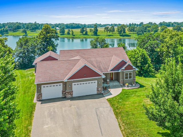 12605 314th St, Lindstrom, MN 55045 - view of front of property featuring driveway, a water view, stone siding, and a garage