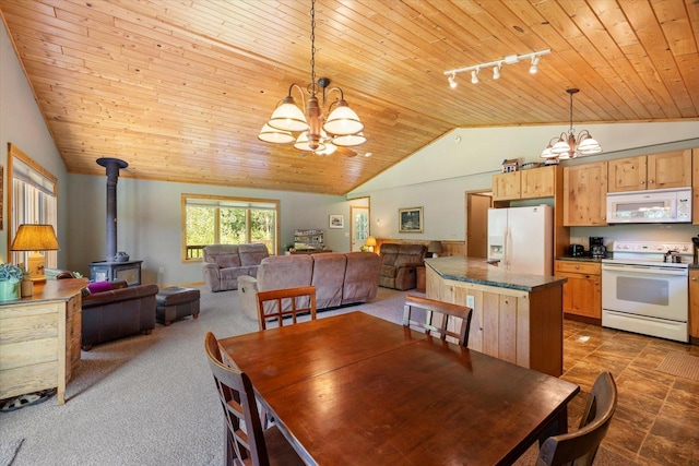 1063 Fernberg Rd, Fall Lake Twp, MN 55731 - dining space with a chandelier, lofted ceiling, wood ceiling, rail lighting, and a wood stove