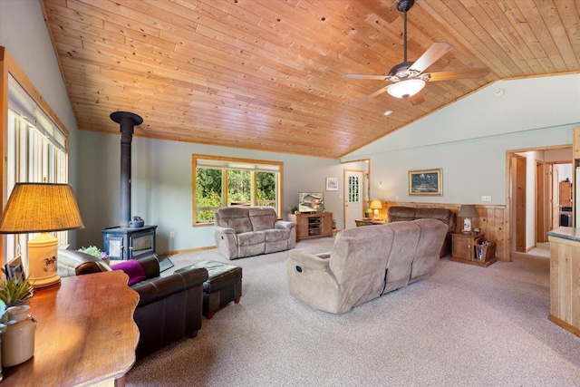 1063 Fernberg Rd, Fall Lake Twp, MN 55731 - carpeted living room with wooden ceiling, a wood stove, lofted ceiling, ceiling fan, and wainscoting