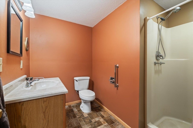 1063 Fernberg Rd, Fall Lake Twp, MN 55731 - bathroom featuring a stall shower, vanity, stone finish flooring, and a textured ceiling