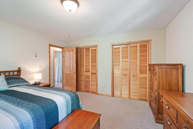 1063 Fernberg Rd, Fall Lake Twp, MN 55731 - bedroom featuring two closets, light carpet, and a textured ceiling
