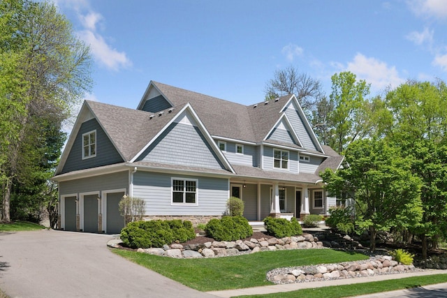 17244 Valley Rd, Eden Prairie, MN 55347 - view of front of house featuring an attached garage, driveway, a porch, and a shingled roof