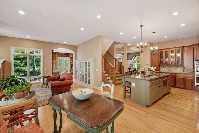 17244 Valley Rd, Eden Prairie, MN 55347 - dining room with arched walkways, light wood-type flooring, recessed lighting, stairway, and a chandelier