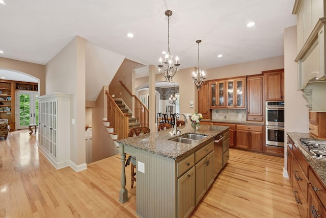 17244 Valley Rd, Eden Prairie, MN 55347 - kitchen featuring stainless steel appliances, a breakfast bar area, light wood-style flooring, a chandelier, and recessed lighting