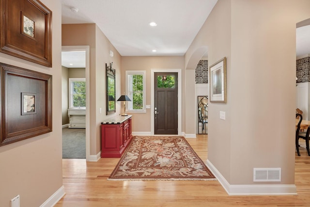 17244 Valley Rd, Eden Prairie, MN 55347 - entryway featuring light wood-style flooring, arched walkways, and recessed lighting