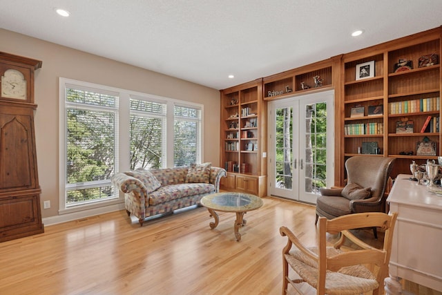 17244 Valley Rd, Eden Prairie, MN 55347 - living room featuring french doors, light wood-style floors, recessed lighting, built in features, and a textured ceiling