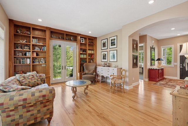17244 Valley Rd, Eden Prairie, MN 55347 - living area with arched walkways, light wood-style floors, recessed lighting, french doors, and built in shelves