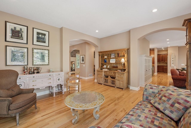 17244 Valley Rd, Eden Prairie, MN 55347 - living room featuring arched walkways, light wood finished floors, and recessed lighting
