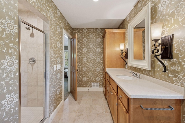 17244 Valley Rd, Eden Prairie, MN 55347 - full bathroom with vanity, wallpapered walls, a shower stall, and tile patterned floors
