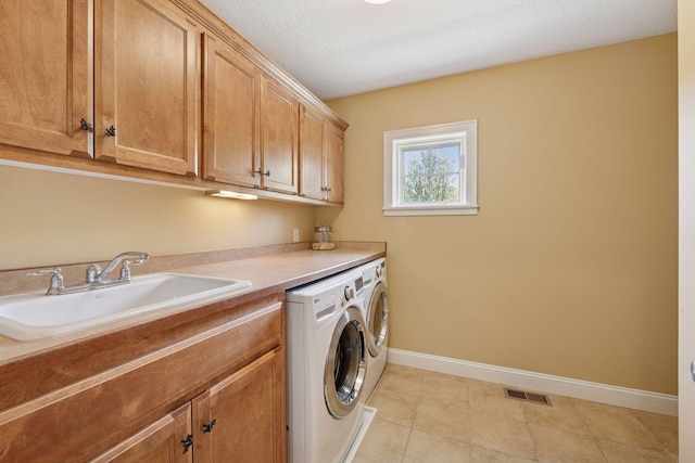 17244 Valley Rd, Eden Prairie, MN 55347 - washroom featuring independent washer and dryer, cabinet space, and light tile patterned floors