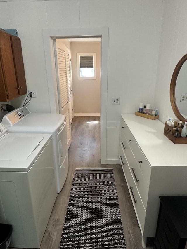502 1st Ave SW, Baudette, MN 56623 - laundry room with cabinet space, washer and clothes dryer, and wood finished floors