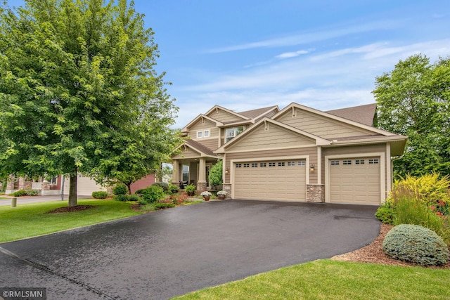 3631 Woodcrest Cir, Eagan, MN 55123 - craftsman inspired home with stone siding, an attached garage, and asphalt driveway