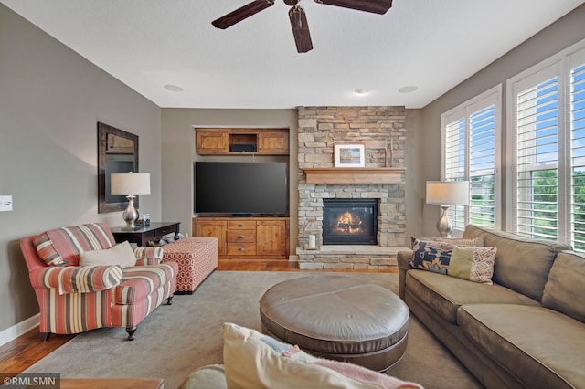 3631 Woodcrest Cir, Eagan, MN 55123 - living area featuring a ceiling fan, wood finished floors, and a stone fireplace