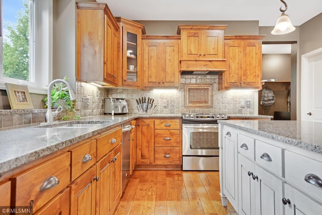 3631 Woodcrest Cir, Eagan, MN 55123 - kitchen featuring light wood finished floors, stainless steel appliances, light stone countertops, glass insert cabinets, and tasteful backsplash