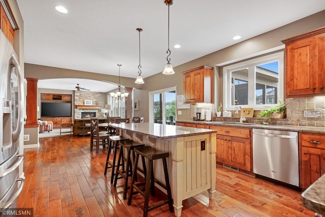 3631 Woodcrest Cir, Eagan, MN 55123 - kitchen featuring stainless steel appliances, open floor plan, light wood-style flooring, decorative backsplash, and recessed lighting