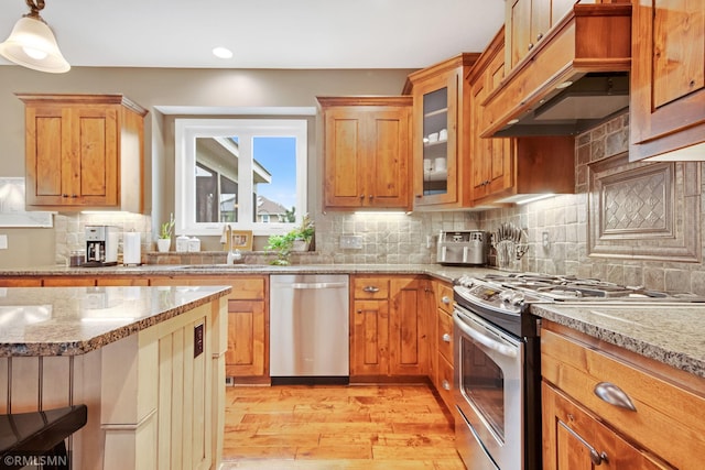 3631 Woodcrest Cir, Eagan, MN 55123 - kitchen featuring stainless steel appliances, light wood-type flooring, custom range hood, light stone counters, and recessed lighting