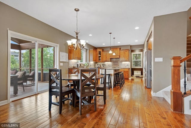 3631 Woodcrest Cir, Eagan, MN 55123 - dining area with stairway, light wood-style flooring, a chandelier, and recessed lighting