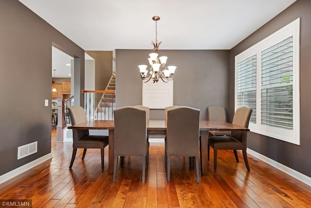 3631 Woodcrest Cir, Eagan, MN 55123 - dining space with light wood-style floors, a chandelier, and stairway