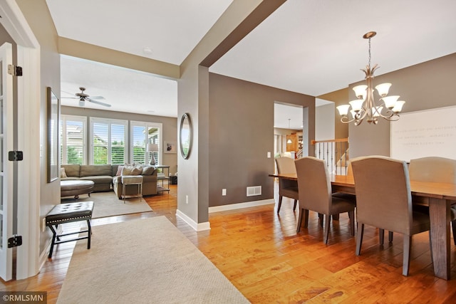 3631 Woodcrest Cir, Eagan, MN 55123 - dining area featuring a chandelier, light wood-type flooring, and a ceiling fan