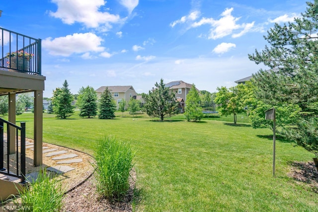 3631 Woodcrest Cir, Eagan, MN 55123 - view of green lawn with a trampoline and a balcony