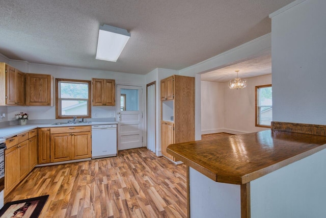 3026 5th Ave E, Hibbing, MN 55746 - kitchen featuring white dishwasher, a textured ceiling, light wood finished floors, a chandelier, and brown cabinets